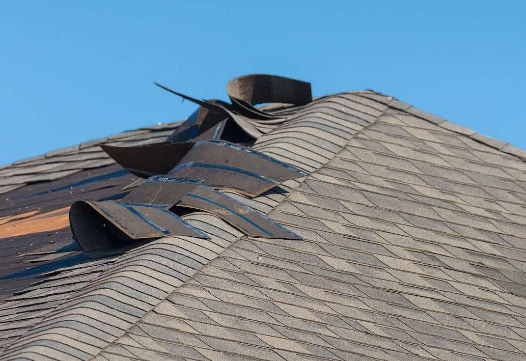 Home Roof With Wind Damage to Shingles