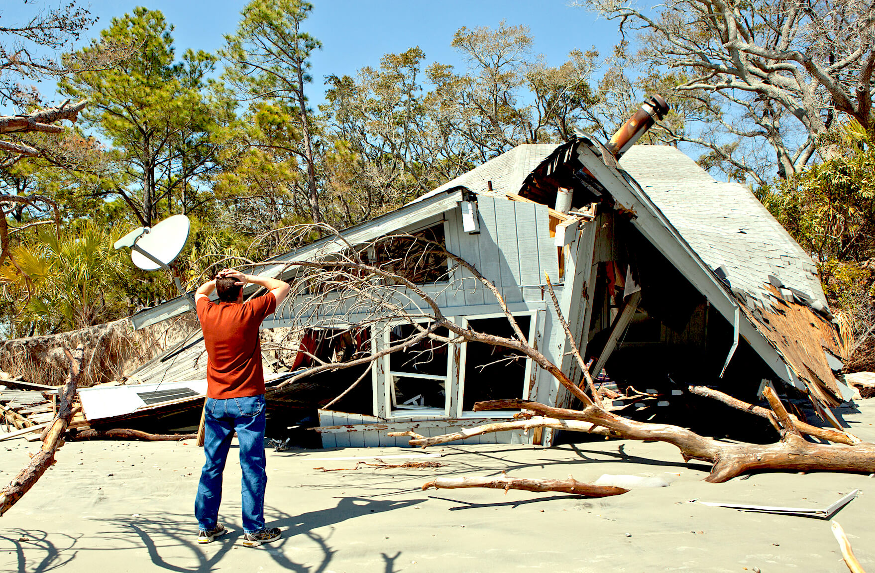 Man in front of House Destroyed by Hurricane
