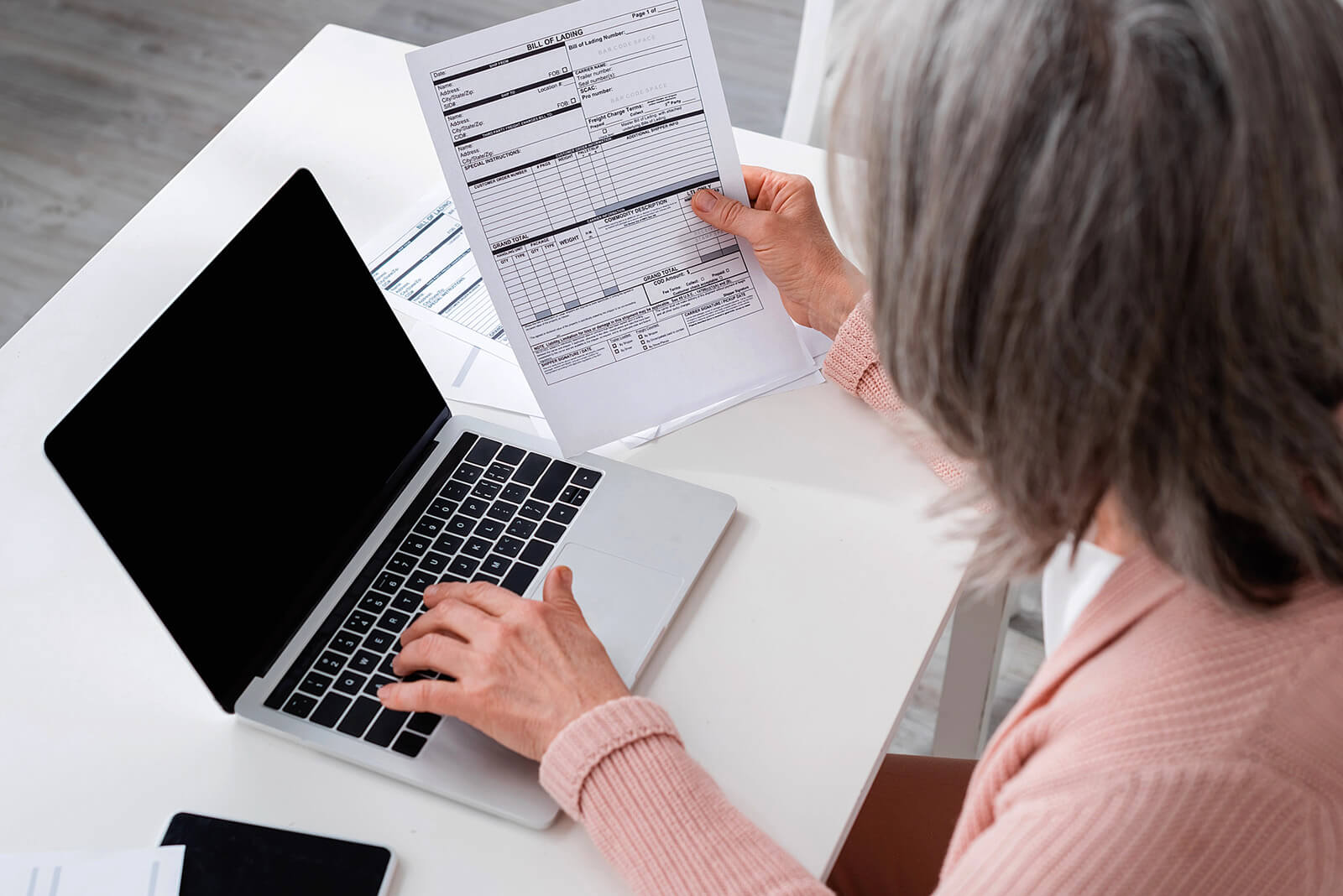 Woman Looking Over Insurance Bills